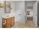 Bathroom with a wooden vanity and a clear view into the living space with fireplace at 1402 Tarleton Ave, Burlington, NC 27215
