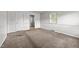 Neutral bedroom featuring carpet flooring, white trim, and a large window at 1402 Tarleton Ave, Burlington, NC 27215