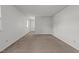 Bright bedroom featuring neutral carpet, white walls, ceiling fan, and natural light at 1402 Tarleton Ave, Burlington, NC 27215