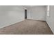 Spacious bedroom with neutral carpet, white walls, natural light, and ample space at 1402 Tarleton Ave, Burlington, NC 27215