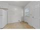 Empty room featuring vinyl flooring, white trim, and a large window at 1402 Tarleton Ave, Burlington, NC 27215