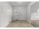 Empty room featuring vinyl flooring, white trim, and a large window at 1402 Tarleton Ave, Burlington, NC 27215