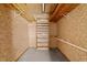 A closet with exposed beams and wooden shelves awaits organizational touches at 1402 Tarleton Ave, Burlington, NC 27215