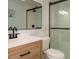 Modern bathroom with wood vanity, large mirror, and glass shower at 1487 Kentucky Ave, Sanford, NC 27332