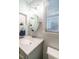 Bright bathroom with marble countertop, crystal lighting, and window at 1487 Kentucky Ave, Sanford, NC 27332