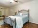 Comfortable bedroom with hardwood floors, a wrought iron bed frame, and natural light at 1487 Kentucky Ave, Sanford, NC 27332