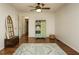 Bright bedroom with polished hardwood floors, ceiling fan, and unique decorative storage at 1487 Kentucky Ave, Sanford, NC 27332