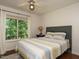 Cozy bedroom with large window, natural light, and ceiling fan at 1487 Kentucky Ave, Sanford, NC 27332