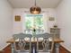 Cozy dining room with a rustic wooden table set for four, under a charming pendant light at 1487 Kentucky Ave, Sanford, NC 27332