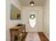 Welcoming entryway with hardwood floors, a decorative rug, stylish table, and an oval window front door at 1487 Kentucky Ave, Sanford, NC 27332
