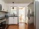 Bright kitchen featuring stainless steel appliances, stylish backsplash, and hardwood floors at 1487 Kentucky Ave, Sanford, NC 27332