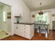Open kitchen with island, stainless steel appliances, and adjoining dining area at 1487 Kentucky Ave, Sanford, NC 27332