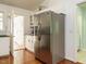 Kitchen featuring stainless refrigerator, white cabinets, and access to laundry and pantry at 1487 Kentucky Ave, Sanford, NC 27332
