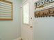 Laundry room featuring exterior access door, organizing racks, and ample wall decor at 1487 Kentucky Ave, Sanford, NC 27332