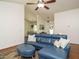Spacious living room featuring a comfortable blue sectional, hardwood floors, and a ceiling fan at 1487 Kentucky Ave, Sanford, NC 27332