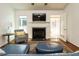 Cozy living room with a fireplace, hardwood floors, and an open doorway leading to an adjacent room at 1487 Kentucky Ave, Sanford, NC 27332