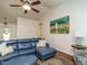 Comfortable living room with hardwood floors, a blue sectional, and a view into the dining area at 1487 Kentucky Ave, Sanford, NC 27332