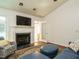 Inviting living room with a fireplace, hardwood floors, and an open doorway to a bright sunroom at 1487 Kentucky Ave, Sanford, NC 27332