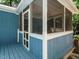 Charming screened-in porch with blue wood and white trim at 1487 Kentucky Ave, Sanford, NC 27332