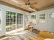 Bright sunroom with large windows, ceiling fan, and tile flooring at 1487 Kentucky Ave, Sanford, NC 27332