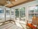 Cozy sunroom with large windows, natural light, tile floor and ceiling fan at 1487 Kentucky Ave, Sanford, NC 27332
