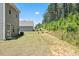 Expansive backyard with lush lawn, mature trees, and ample space for outdoor activities and gardening at 150 Ivy Bank Dr, Angier, NC 27501