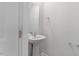 Stylish half bathroom featuring a modern pedestal sink and mirror at 150 Ivy Bank Dr, Angier, NC 27501
