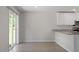 Bright dining area with hardwood flooring, sliding glass doors, and a modern kitchen at 150 Ivy Bank Dr, Angier, NC 27501