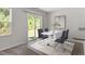 Bright dining area with a modern table, stylish chairs, and a sliding glass door to the backyard at 150 Ivy Bank Dr, Angier, NC 27501