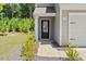 Close up of front door showing house number, with manicured landscaping, and attached garage at 150 Ivy Bank Dr, Angier, NC 27501