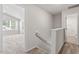 Upstairs hallway leading to a bright bedroom and bathroom at 150 Ivy Bank Dr, Angier, NC 27501