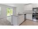 Bright kitchen features stainless steel appliances, granite counters, and a sliding door to the backyard at 150 Ivy Bank Dr, Angier, NC 27501