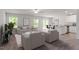 Open living area with neutral colors, plush carpeting, and abundant natural light from large windows at 150 Ivy Bank Dr, Angier, NC 27501
