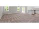 Spacious living area with large windows, sliding door to yard, and an adjacent kitchen area at 150 Ivy Bank Dr, Angier, NC 27501
