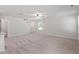 Open living area with neutral carpet, staircase, and access to the kitchen area at 150 Ivy Bank Dr, Angier, NC 27501