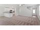 Open-concept living area with modern lighting, neutral paint, carpet, and an open kitchen at 150 Ivy Bank Dr, Angier, NC 27501