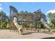 Community playground featuring enclosed slide with climbing structure and engineered wood fiber safety surface at 150 Ivy Bank Dr, Angier, NC 27501