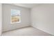 Comfortable bedroom with neutral carpet and a window providing a scenic outdoor view at 150 Rusling Leaf Dr, Fuquay Varina, NC 27526