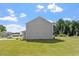 Exterior view of the house showing the siding, large yard and green trees at 154 Taverners Ln, Angier, NC 27501