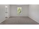 A serene bedroom featuring plush carpeting, a window, and neutral color palette at 154 Taverners Ln, Angier, NC 27501