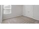 A spare bedroom offers neutral carpet and walls and a closet with double doors at 154 Taverners Ln, Angier, NC 27501