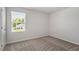 Comfortable bedroom with neutral carpet and a large window, offering a cozy and inviting atmosphere at 154 Taverners Ln, Angier, NC 27501