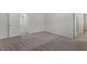 Spacious bedroom with neutral carpet, multiple doorways, and abundant natural light creates a tranquil atmosphere at 154 Taverners Ln, Angier, NC 27501