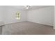 Spacious bedroom with neutral carpeting, natural light, and a ceiling fan at 154 Taverners Ln, Angier, NC 27501