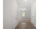 Bright hallway leading to a living area with neutral carpet and a ceiling fan at 154 Taverners Ln, Angier, NC 27501