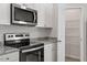 Well-equipped kitchen boasts stainless steel appliances, granite countertops, and ample storage space with white cabinets at 154 Taverners Ln, Angier, NC 27501
