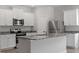 Modern kitchen with stainless steel appliances, an island, and granite countertops at 154 Taverners Ln, Angier, NC 27501