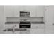 Bright kitchen with stainless steel appliances and granite countertops, featuring a convenient oven and microwave at 154 Taverners Ln, Angier, NC 27501