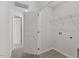 Pass through laundry room with vinyl flooring, utility shelf and hookups in an open hall at 154 Taverners Ln, Angier, NC 27501