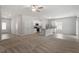 Open-concept living room and kitchen with neutral carpeting and an eat-in island at 154 Taverners Ln, Angier, NC 27501